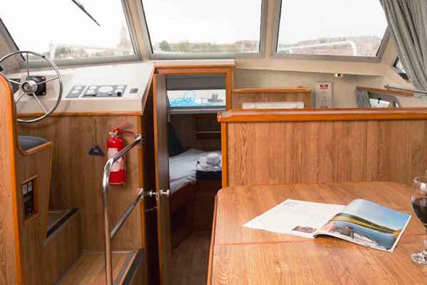 The inside steering position on the Crusader hire boat.