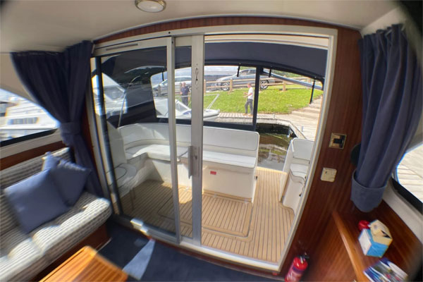 Cabin with sliding doors to rear deck on the Noble Lady hire boat.